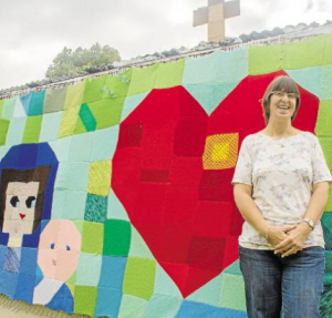 Wendy Sneddon displaying the giant blanket outside St Francis's church hall in Medowie, Port Stephens.