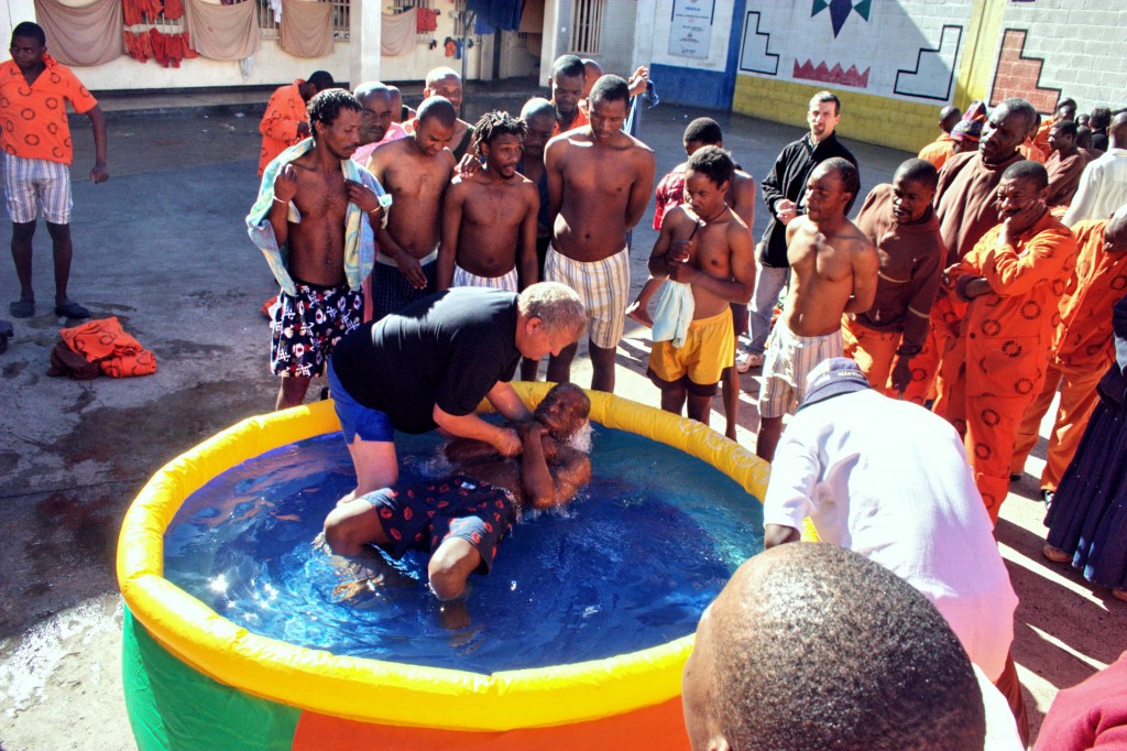 Pastor Willie Dengler conducts a baptism behind prison walls.