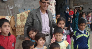 A group of Christians whose families have fled their homes, outside makeshift housing in Erbil in northern Iraq. Photo: Bible Society