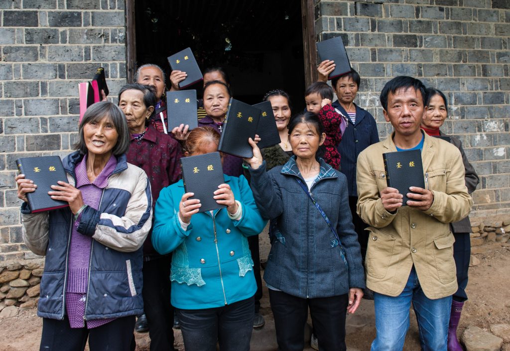 Some of the members of Luo Shui Church with Bibles they have received from Bible Societies. Thirty Christians meet regularly in this small farmhouse that serves as the building for Luo Shui Church, some of them walking for hours through the mountains each week to get here. Members can only reach the church by using stepping stones to cross a stream, and most of them are very poor. 
