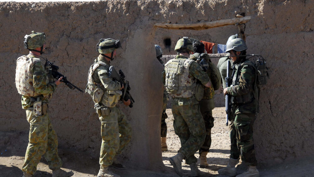 Australian and Afghan National Army soldiers work together to search the Mirabad Valley Region for weapons and Improvised Explosive Device components.