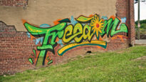 Freedom graffitied on a park wall