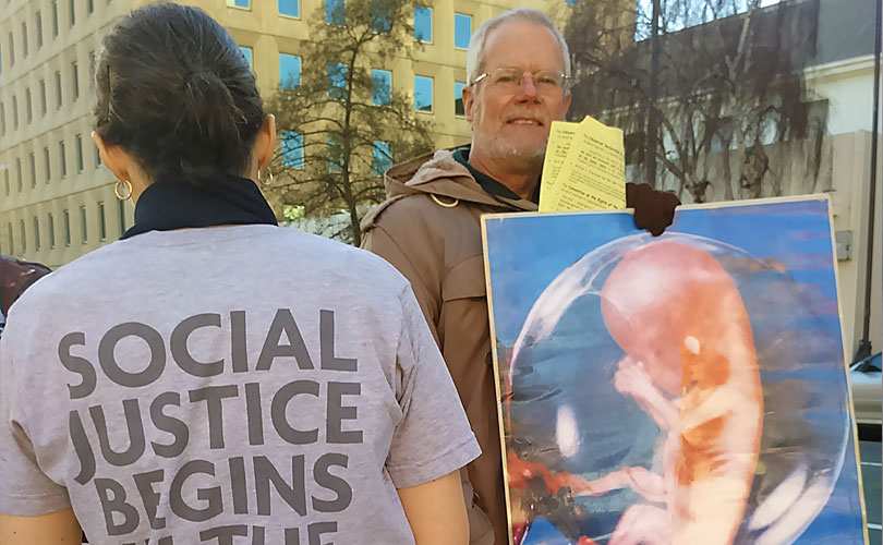 Graham Preston protests outside a Hobart abortion clinic