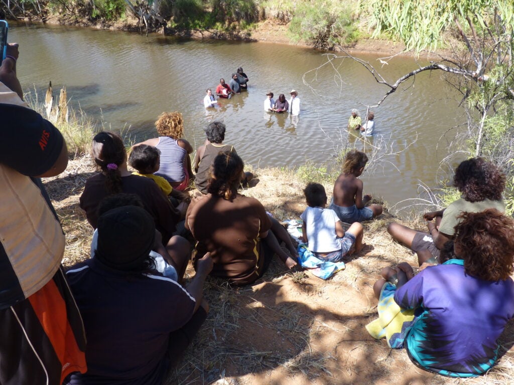 Members of the Mungkarta community enjoy the baptism scene in the McLaren River.