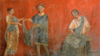 Workers put up clothes for drying in an ancient artwork from Pompeii.
