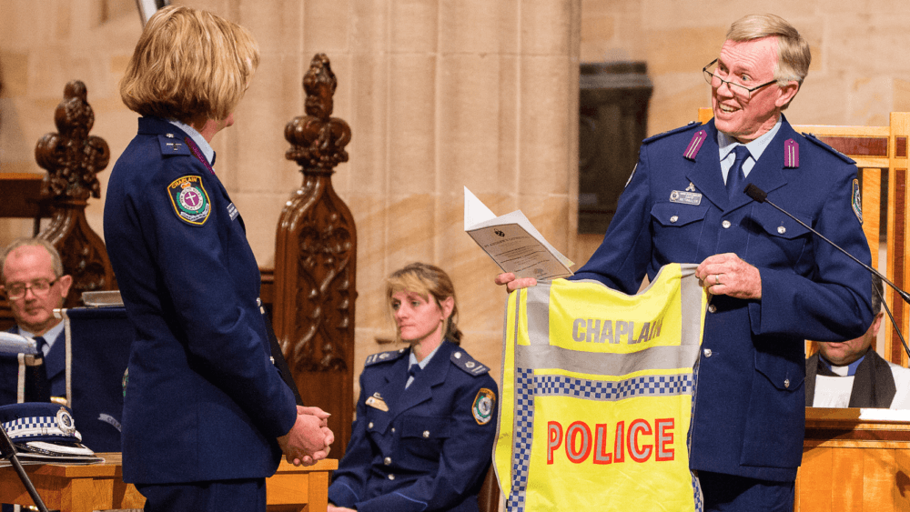 Senior State Chaplain David Riethmuller hands Rev Sarah Plummer her police chaplain vest