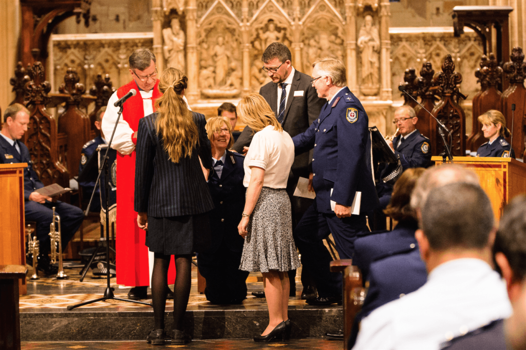 Senior State Chaplain David Reithmuller, Rev Dr Andrew Ford, Kalista Plummer, Diane Trainor and Archbishop Glenn Davies pray for Rev Sarah Plummer