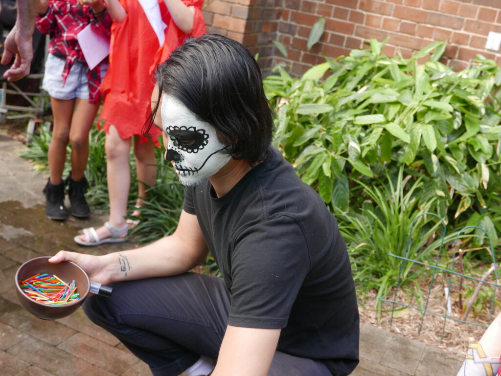 A church volunteer helps children go slime fishing