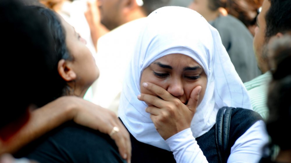 A Muslim girl supports her Christian friend after her brother was killed during the battles of Maspero, Egypt, 2011