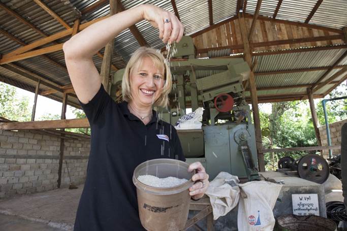 The new CEO admires the rice produced from a mill which World Vision Australia helped the local community establish