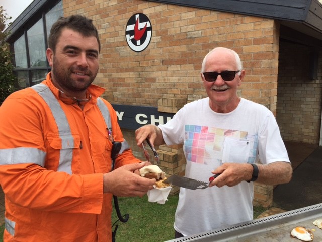 Harvey Weir, right, serves breakfast to Rohan Myers at Wesley Castle Hill Uniting Church.