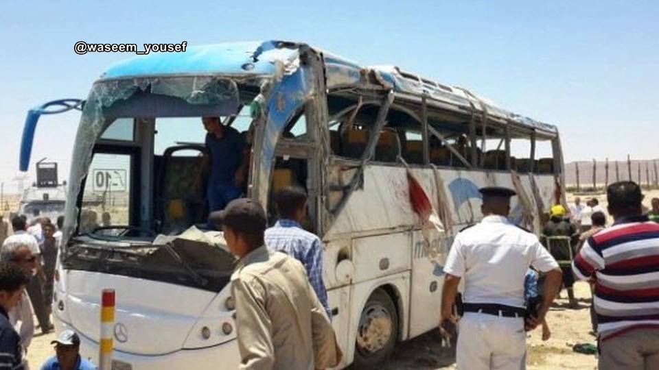 Police inspect a bus that was attacked south of Cairo on Friday