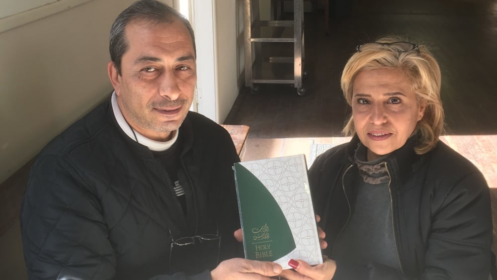 Rafi, left, and Fadia Eskeif with the Arabic-English Bible they received this week.