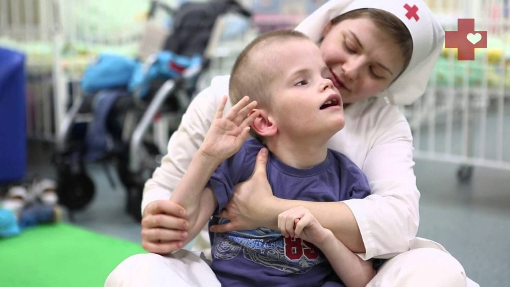 A sister of mercy takes care of a disabled child