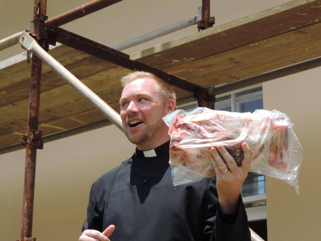 David Fell auctions off some meat as part of the Thanksgiving festivities.