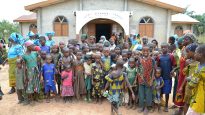 People gather outside a Nigerian Reformed Church Onuenyim Iseke