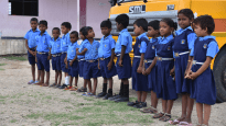 Children in front of their new school bus, August 2017.