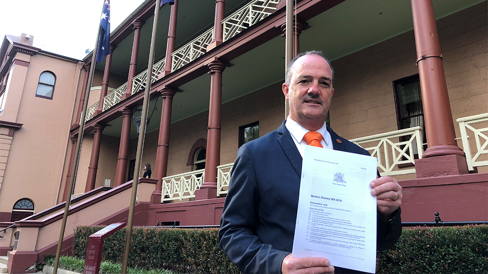 Paul Green with the Modern Slavery Bill outside the NSW parliament.