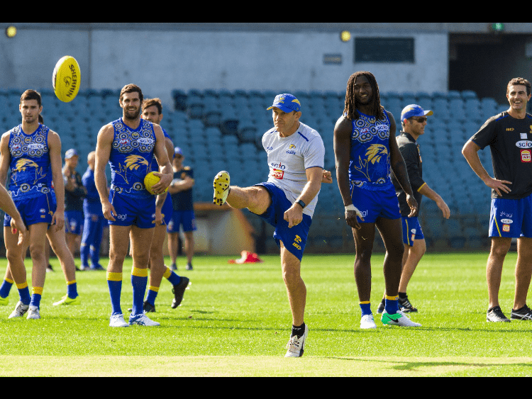 Paul "Morro" Morrison kicks a ball with star player Nic Natanui at right.