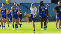 Paul "Morro" Morrison kicks a ball with star player Nic Natanui at right.