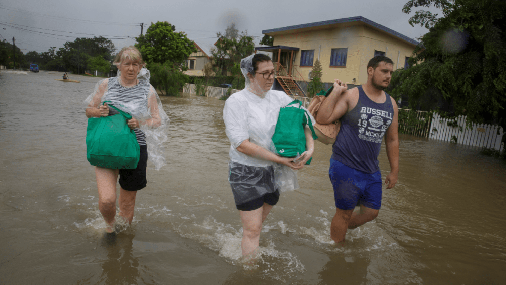 Flood-affected residents evacuate their home in Townsville.