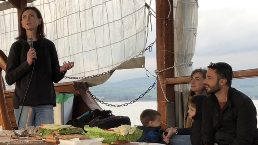 Moshe and Jeannette Gabay and their sons listen as Pastor Catrina Henderson shares on the Sea of Galilee.