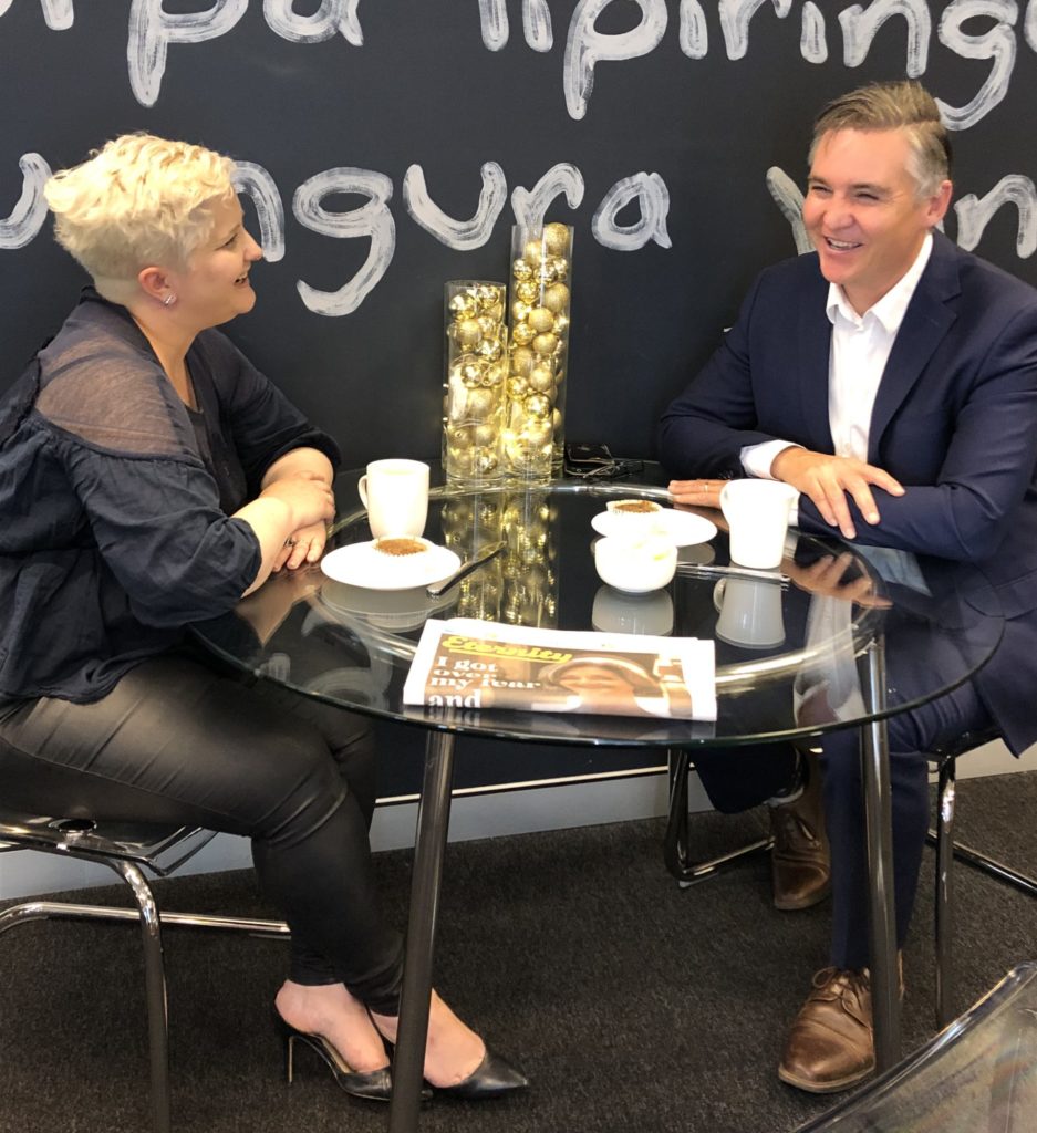 Megan Powell du Toit and Michael Jensen tuck into a "Tumnus cake" in the Eternity offices