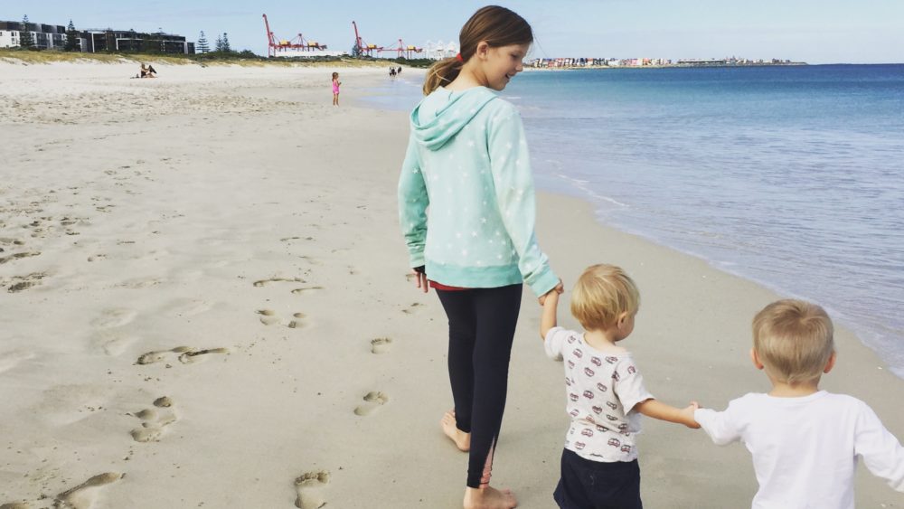 Children walk on beach