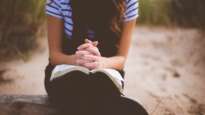 Woman meditating on Bible