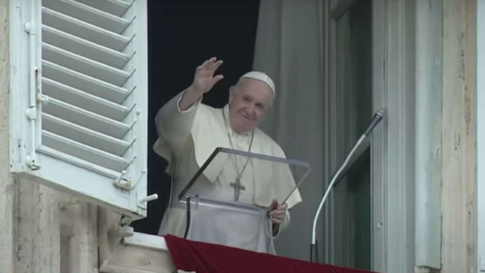 Pope Francis waves from his apartment window overlooking St Peter's Square