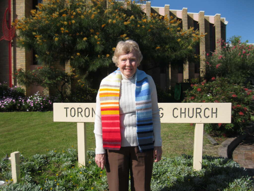 Knitter Laraine Jones from Toronto Uniting Church, NSW, proudly shows her scarf