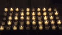 Washington Cathedral candles flicker as mourning bell tolls 500 times for 500,000 COVID deaths.