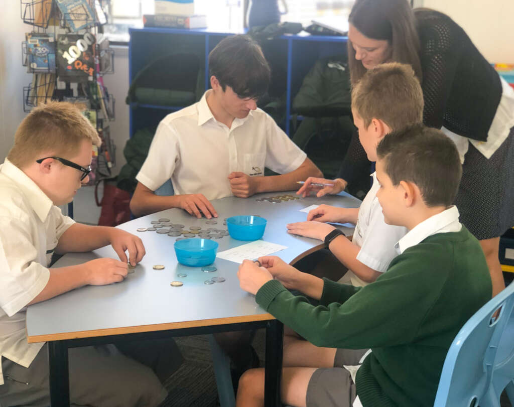New Hope students engage in a practical maths lesson