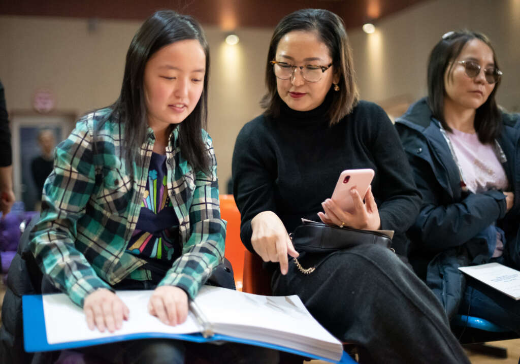 Saikhantsetseg, 19, reads from one of the volumes of the newly-published full Braille Bible in Mongolian, which was launched in late 2020. Image: Mongolian Union Bible Society