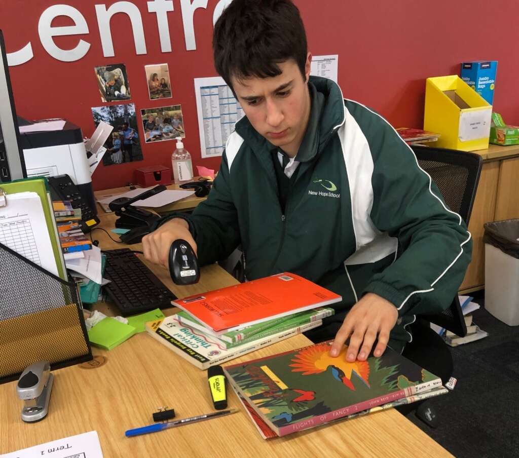 New Hope student Xavier at work experience in Pacific Hills school library