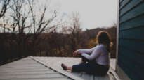 Woman overlooking rooftops. Image: Aidan Meyer / Magdeleine