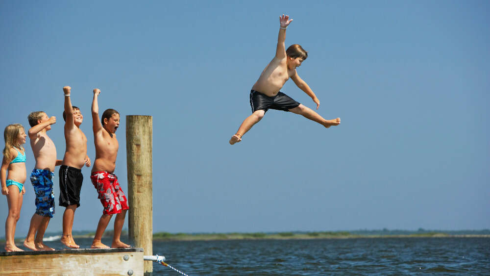 Kids jumping off jetty