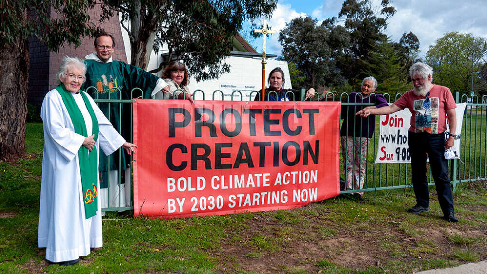 Leaders and worshippers at St Mary's Holy Cross Anglican Church Hackett, Canberra with their Faiths4climate banner.