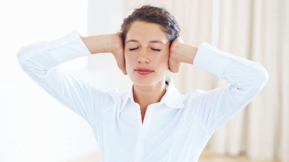 Woman covering her ears