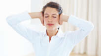Woman covering her ears