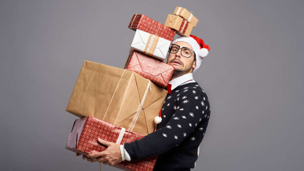 Man carrying a lot of presents
