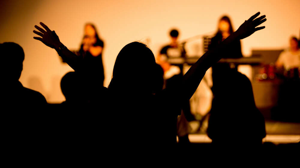 Woman worshipping in church