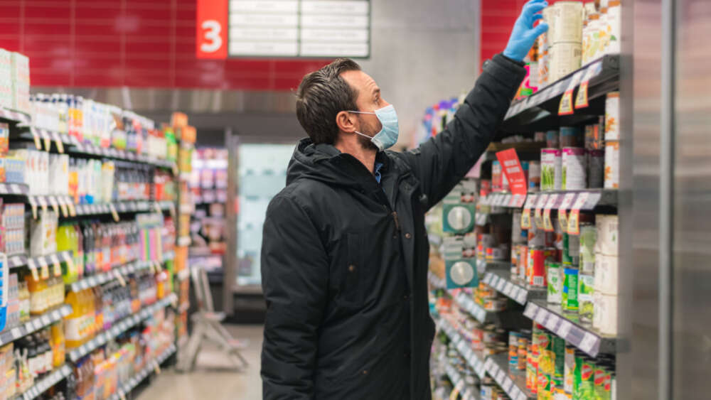 Man in gloves and mask in grocery store