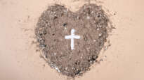 Heart with cross drawn in ashes