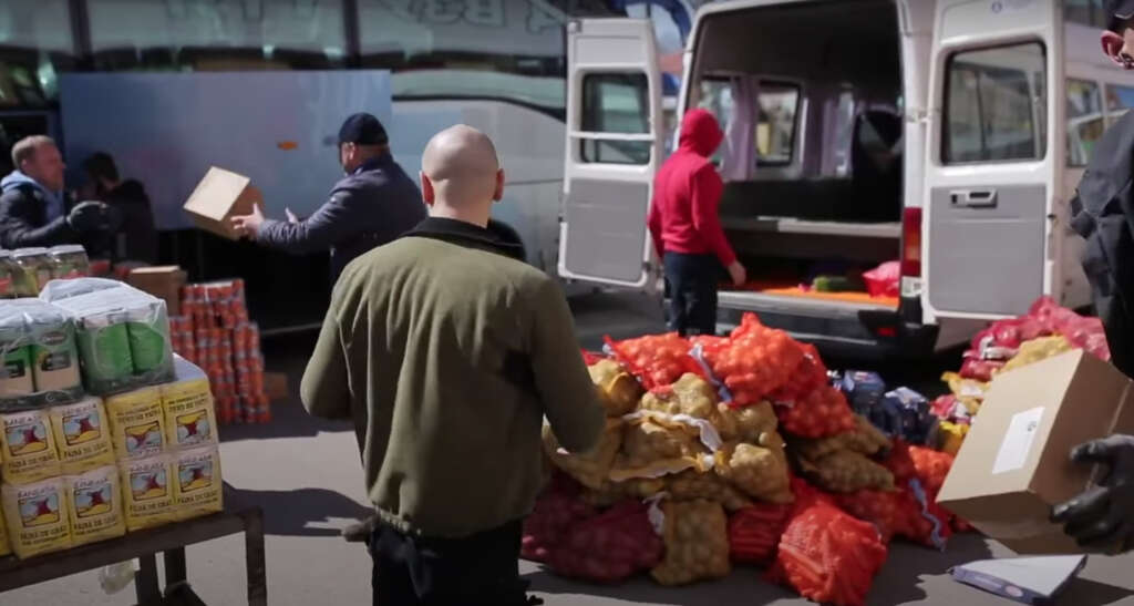 Aid supplies are unloaded by sports ministry volunteers in Ukraine