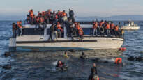 Syrian and Iraqi refugees arrive from Turkey to Skala Sykamias, Lesbos island, Greece. Volunteers (life rescue team - with yellow-red clothes) from the Spanish NGO Proactiva Open Arms help the refugees. Image: Ggia