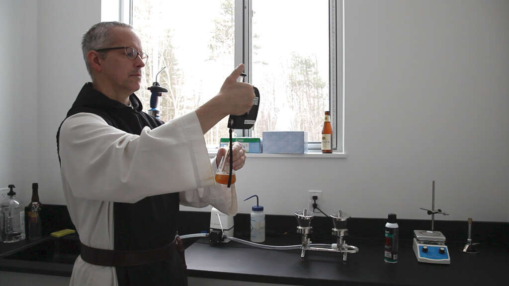 A monk at work in the Spencer Brewery lab. Image: Spencer