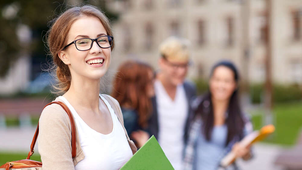 happy teenage students with school folders