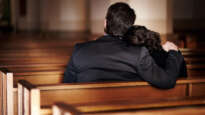Man and wife mourning in church