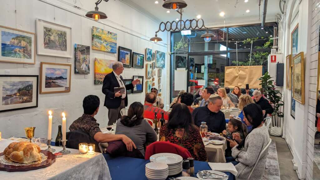 Bob Mendelsohn speaks to the gathered crowd at the Jews for Jesus art exhibition